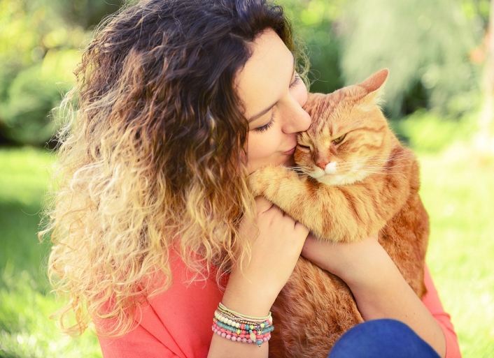 483467294 Woman holding orange cat